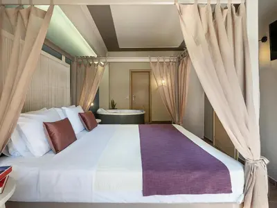 a bedroom with a large bed and a bath tub at Elia Potie in Chania Town