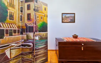 a room with a dresser and a painting on the wall at Aphrodite House in Chania Town