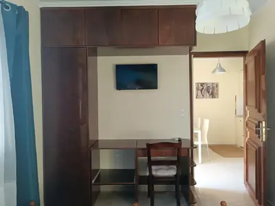 a room with a desk and a table and a chair at Rayon De Soleil in Chania Town