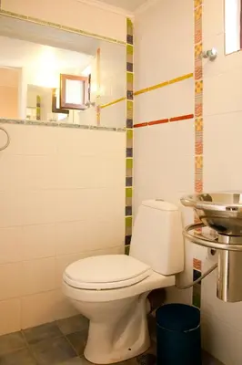 a bathroom with a toilet and a sink at Rayon De Soleil in Chania Town