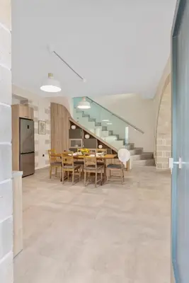 a kitchen and dining room with a table and chairs at Brand new Villa Volakas BY APOKORONAS VILLAS in Gavalochori