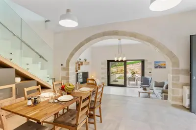 a kitchen and dining room with a table and chairs at Brand new Villa Volakas BY APOKORONAS VILLAS in Gavalochori