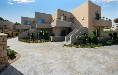 a large house with a driveway in front of it at Villaggio Mare Suites in Kalamaki Chanion