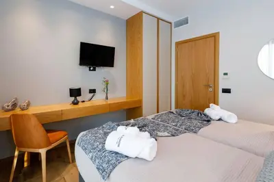 a hotel room with two beds with towels at Exquisite Crete Villa Villa Kleanthi 4 Bedroom Private Pool in Stalos