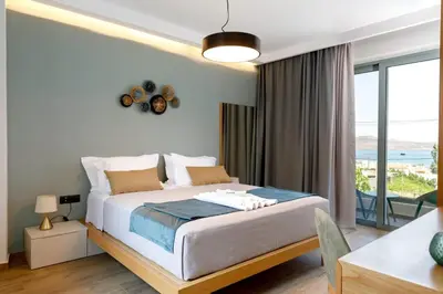 a bedroom with a bed and a large window at Exquisite Crete Villa Villa Kleanthi 4 Bedroom Private Pool in Stalos
