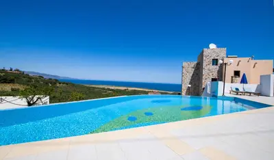 a swimming pool with a view of the ocean at Iliada by Vintage Travel in Maleme
