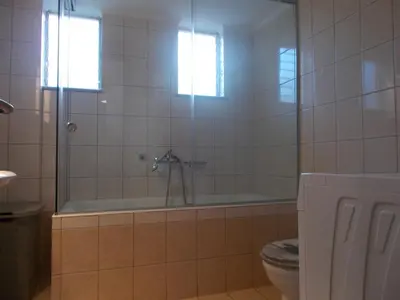 a bathroom with a tub and a toilet at K_Kostas Apartment in Daratso