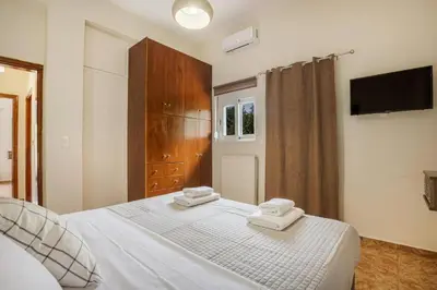 a bedroom with a bed with two towels on it at K_Kostas Apartment in Daratso