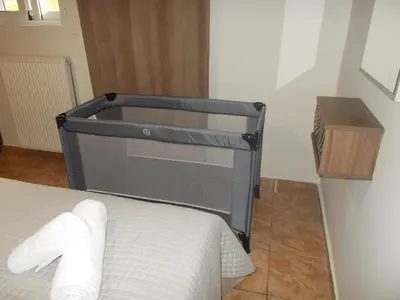 a bed in a room with a bed frame at K_Kostas Apartment in Daratso