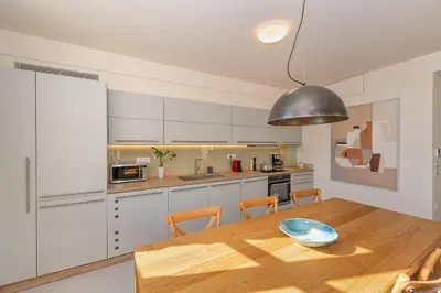 a kitchen with a wooden table with a bowl on it at Hippocampo Waterfront Villa in Chania Town