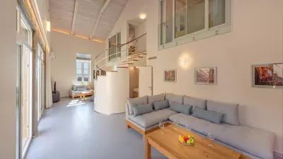 a living room with a couch and a table at Hippocampo Waterfront Villa in Chania Town