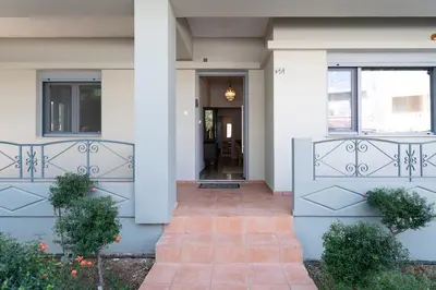 a front door of a white house with a porch at Suncatcher House by 8essentially in Chania Town