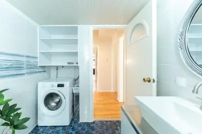 a bathroom with a washing machine and a sink at Suncatcher House by 8essentially in Chania Town