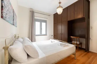 a bedroom with a large bed with white pillows at Suncatcher House by 8essentially in Chania Town