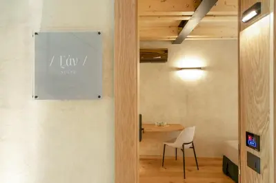 a dining room with a table and a chair at Poem Suites in Chania Town