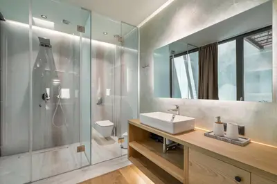 a bathroom with a sink and a shower at Poem Suites in Chania Town