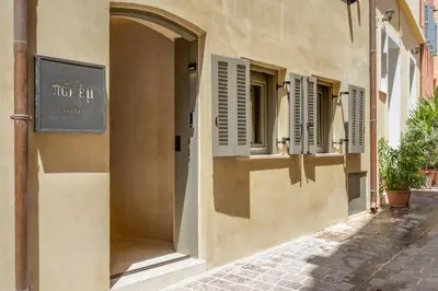 a building with shuttered windows on a street at Poem Suites in Chania Town