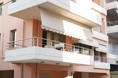 an apartment building with white balconies on it at Aeri Home - At Nea Chora beach w. Parking included in Chania Town