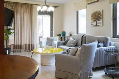 a living room with a couch and a table at Aeri Home - At Nea Chora beach w. Parking included in Chania Town