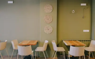 a room with two tables and white chairs at Kumba in Nea Chora in Chania Town