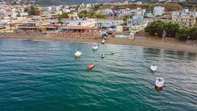 a group of boats in the water near a beach at On the Beach in Kissamos