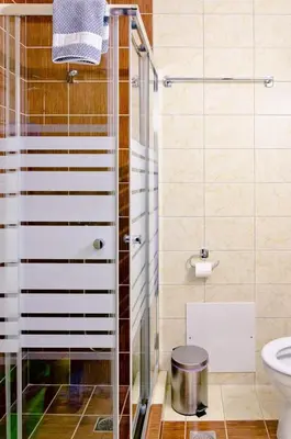 a bathroom with a glass shower and a toilet at On the Beach in Kissamos