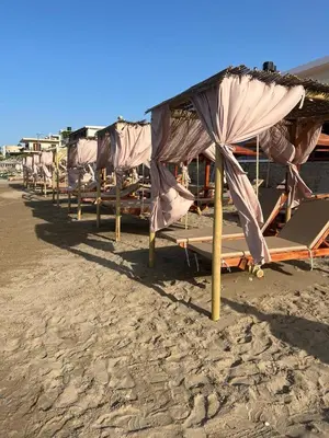 a row of umbrellas on a sandy beach at On the Beach in Kissamos
