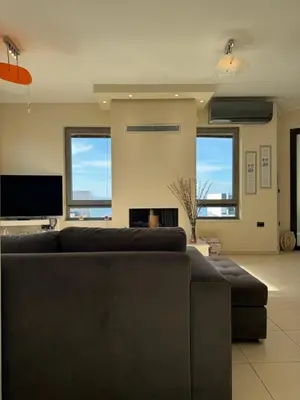 a living room with a couch and a fireplace at Seaty Luxury apartment in Chania Town