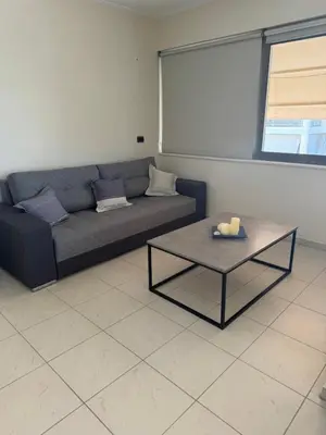 a living room with a couch and a table at Seaty Luxury apartment in Chania Town