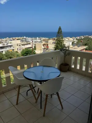 a patio with a table and chairs on a balcony at Stephanie's Place - Charming Apartment with Sea View in Chania Town