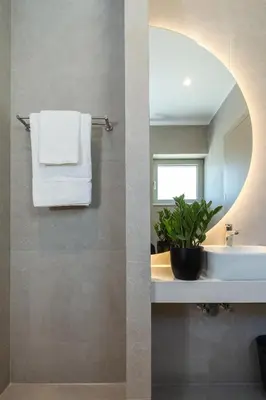 a bathroom with a sink and a mirror at Cove Elafonisi Apartments in Elafonisi