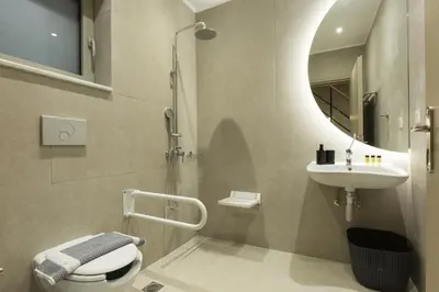 a bathroom with a sink and a toilet and a mirror at Cove Elafonisi Apartments in Elafonisi