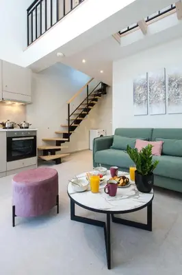a living room with a green couch and a table at Cove Elafonisi Apartments in Elafonisi