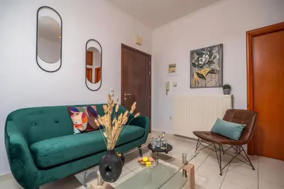 a living room with a green couch and a table at Ammoutsiani 2 Cozy Apartment by 8essentially in Chania Town