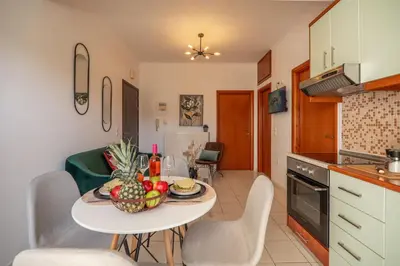 a kitchen with a table with a bowl of fruit on it at Ammoutsiani 2 Cozy Apartment by 8essentially in Chania Town