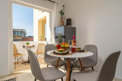a dining room with a table with a bowl of fruit on it at Ammoutsiani 2 Cozy Apartment by 8essentially in Chania Town