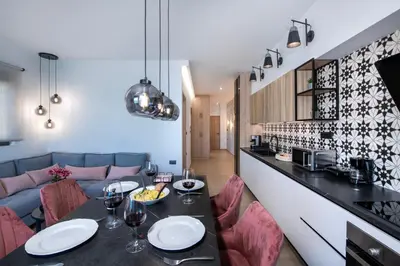 a living room with a couch and a table with chairs at ALPHA SUITES in Chania Town