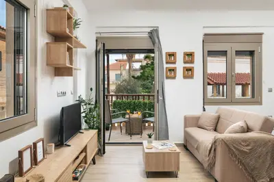 a living room with a couch and a tv at ModernPastel Studio-Near Old Port in Chania Town