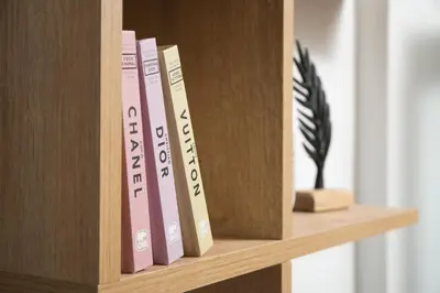 a row of books on a wooden book shelf at ModernPastel Studio-Near Old Port in Chania Town