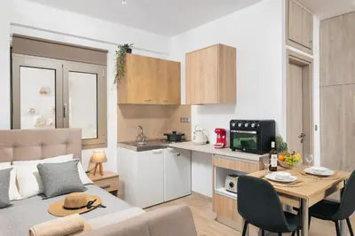 a small apartment with a kitchen and a dining table at ModernPastel Studio-Near Old Port in Chania Town