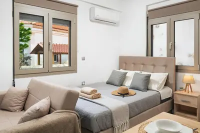 a bedroom with a bed and a couch at ModernPastel Studio-Near Old Port in Chania Town