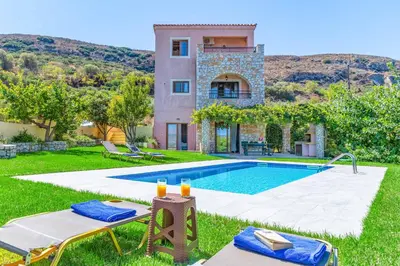 a villa with a swimming pool and a house at Villa Koule in Kalami