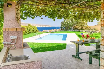 a patio with a sink and a swimming pool at Villa Koule in Kalami