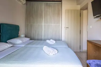 two beds in a room with towels on them at Villa Koule in Kalami