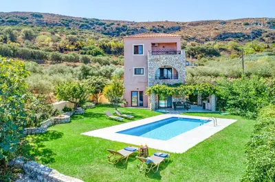 an external view of a villa with a swimming pool at Villa Koule in Kalami