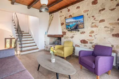 a living room with two chairs and a table at Villa Koule in Kalami
