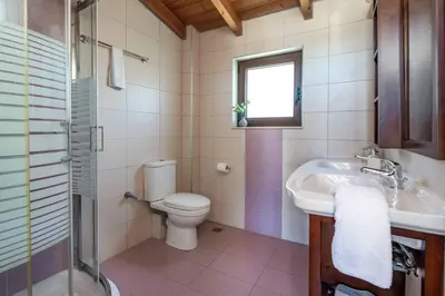 a bathroom with a toilet and a sink at Villa Mandarin Platanias in Plataniás