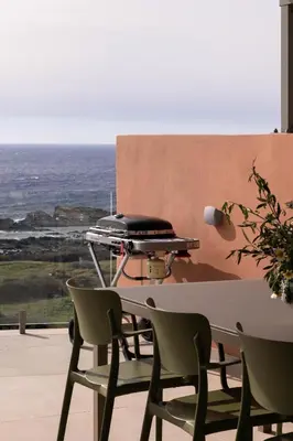 a barbecue grill sitting on a table on a patio at Casa Tarrha- Beachfront Villa with Heated Pool in Livadia