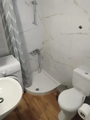 a white bathroom with a toilet and a sink at Lenio's Apartment in Souda