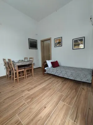 a living room with a bed and a table at Lenio's Apartment in Souda